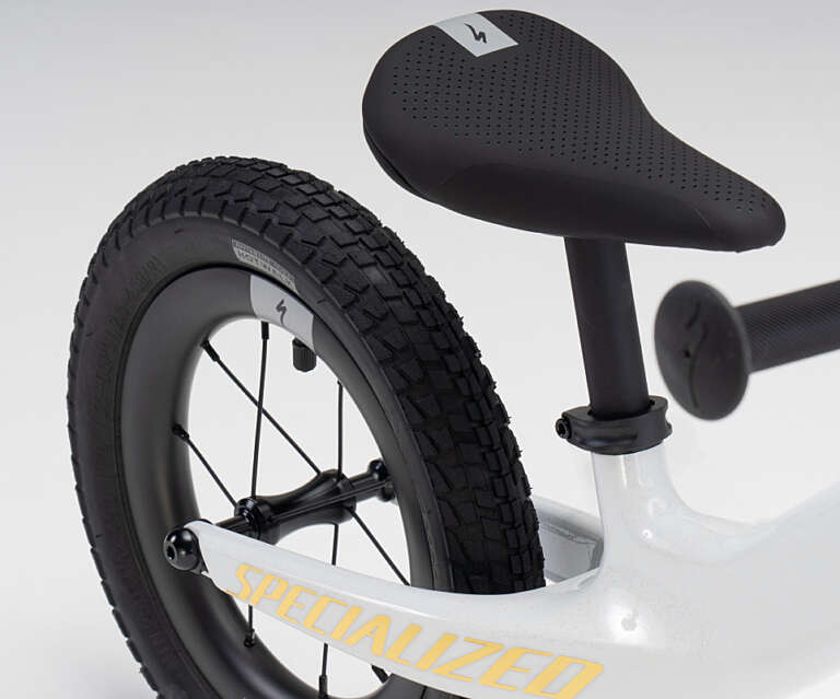 Weißes Specialized Hotwalk Limited Edition Laufrad Fokus auf Hinterrad und Sattel